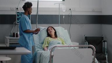 非洲式发型美国阿斯坦特检查生病的女人坐着床上医院病房